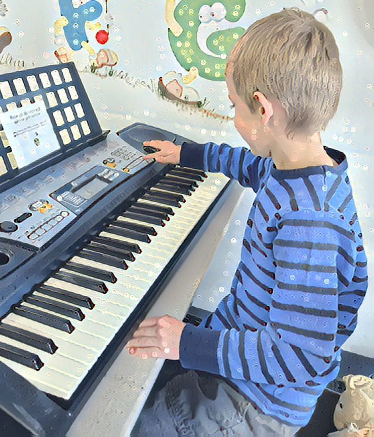 Little boy playing piano. Screen free kids are more creative!